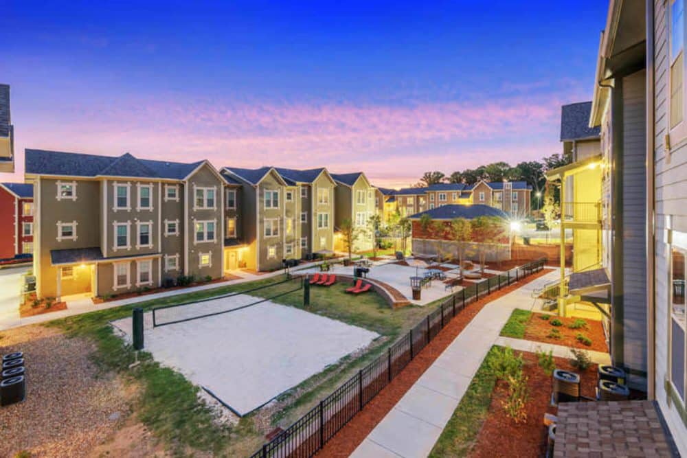 millenium one off campus apartments near the university of north carolina charlotte unc charlotte uncc aerial view of sand volleyball court and outdoor study garden