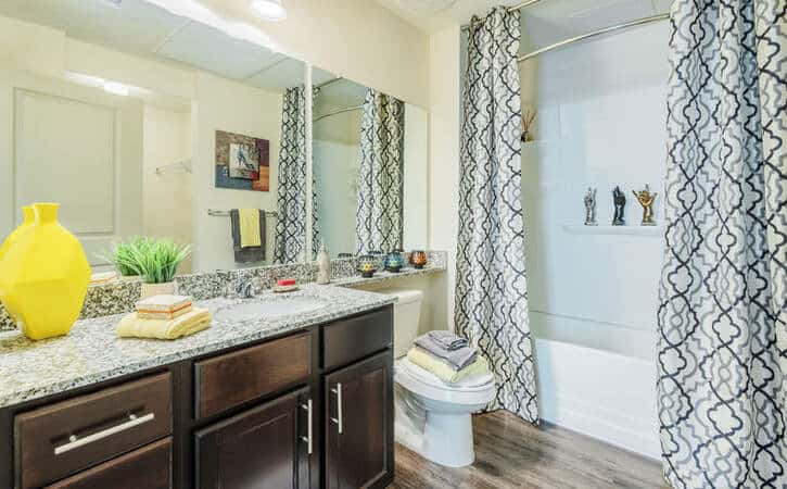 private bathroom wood style flooring shower with tub millenium one apartments charlotte near uncc